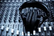 stock-photo-19042315-studio-headphones-and-mixing-board.jpg
