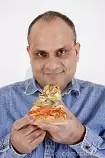 images/guy-eating-pizza-slice-12749127.jpg